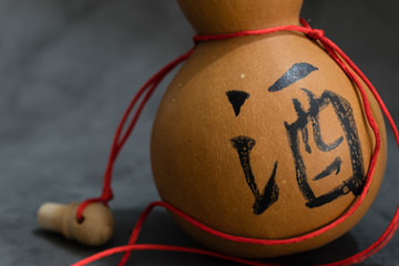 Dried bottle gourd on black background view,the chinese means is wine