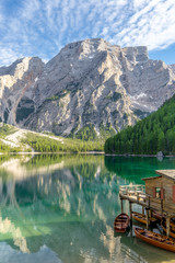Sunset mountain reflections and the boathouse at the Pragser Wildsee, Lake Prags, Lake Braies, South Tyrol, Italy 