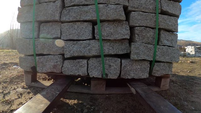 Forklift lifting pallet with granite blocks
