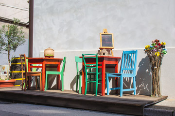 colorful chairs and tables in front of a restaurant in the old town of Pula, Istrian Peninsula,...