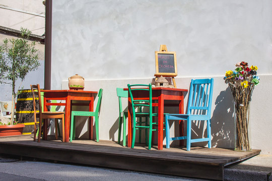 Fototapeta colorful chairs and tables in front of a restaurant in the old town of Pula, Istrian Peninsula, Croatia