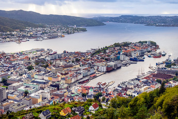 Naklejka na ściany i meble Bergen, Norway - Panoramic city view with Bergen Vagen harbor - Bergen Havn - and historic Bryggen heritage district seen from Mount Floyen
