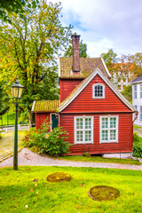 Fototapeta na wymiar Bergen, Norway - Reconstructed XIX century Norwegian city street with wooden houses in Old Bergen Museum - Gamle Bergen Museum - heritage park