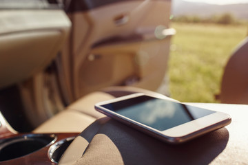 smart phone phone on the car seat dashboard