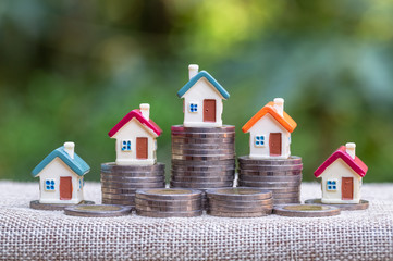 Mini house on stack of coins,Money and house, Mortgage concept, Real estate investment, Save money with stack coin.