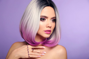 Beautiful lady presents amethyst ring and bracelet jewelry set. Woman portrait with ombre bob short hairstyle and manicured nails. Beauty makeup. Gorgeous model isolated on purple background.