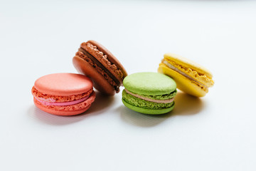 Colorful macaroons. French dessert multicolored cake on a white background. Fragrant dessert.