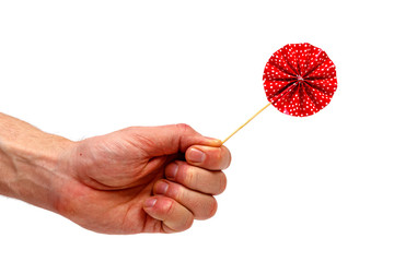 Male hand holding lollipop isolated on white background. Minimalistic concept.