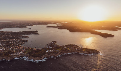 Panoramic aerial drone view of South Head, a headland peninsula near the suburb of Watsons Bay in Sydney, New South Wales, Australia. Harbour and city centre in the background.