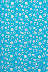 Beautiful calico texture with embroidered flowers on a calm plain background