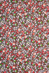 Beautiful calico texture with embroidered flowers on an active background