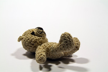 Cute brown crochet teddy bear with white background