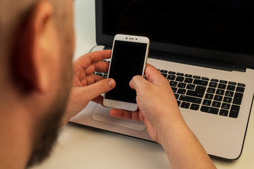 A hand holding a cellphone