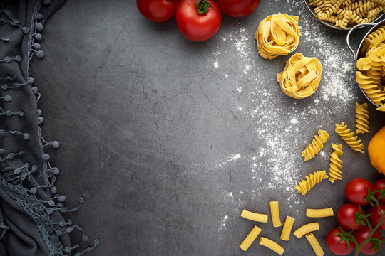 Still life of tortellini, tagliatelle, tortiglioni, fusilloni, casarecce, spaghhetti, macoroni, tomato, mushroom, pepper, olive oil