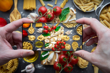 Still life of tortellini, tagliatelle, tortiglioni, fusilloni, casarecce, spaghhetti, macoroni, tomato, mushroom, pepper, olive oil
