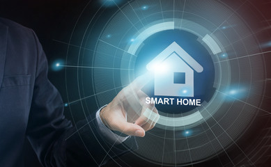 Internet of things. Unrecognizable businessman pressing shiny SMART HOME icon on transparent screen, collage