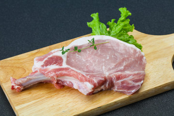 Raw pork bone steak over wooden