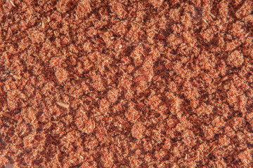 Background with scattered ground cinnamon at high magnification