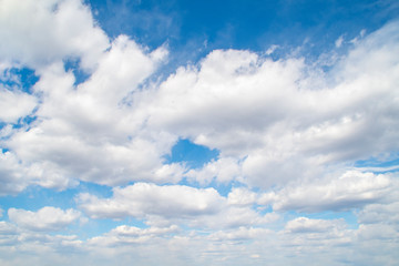 Naklejka na ściany i meble Horizontal view of a light, blue sky with white clouds. Airy, vibrant atmosphere