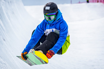 Snowboarder during a trick on a slope