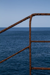 Rusted railing and Mediterranean sea