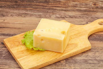 Emmental cheese over wooden board
