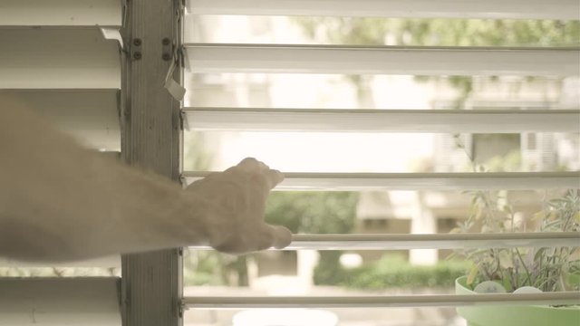 Hand Opening Window Shutters - POV Of A Person Looking Outside The Window. Man Spying Outside Scared