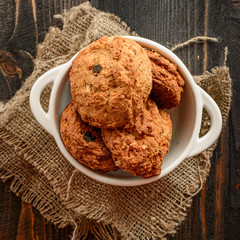golden brown homemade oatmeal cookies on dark table