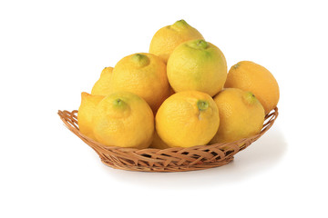 Lemons in wicker basket isolated on white