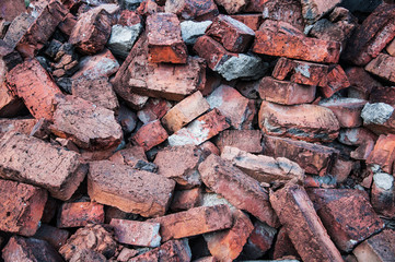 the bricks are on the heap. orange briquettes in a chaotic manner