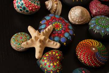 Starfish with shells and painted rock mandala