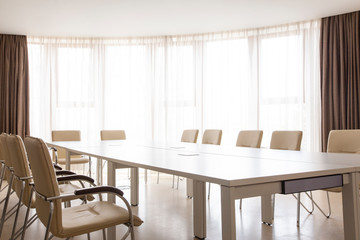 Fototapeta premium Meeting room with panoramic window. Table and chairs