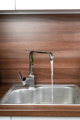 chrome tap and sink in a rustic kitchen
