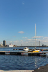 Dock with yachts on the Daugava river. City of Riga and sailboats on the foreground.