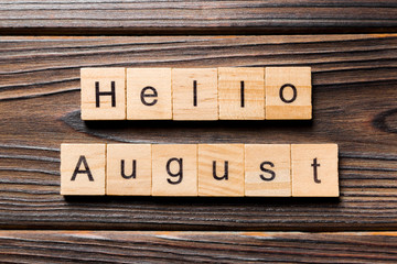 hello august word written on wood block. hello august text on table, concept