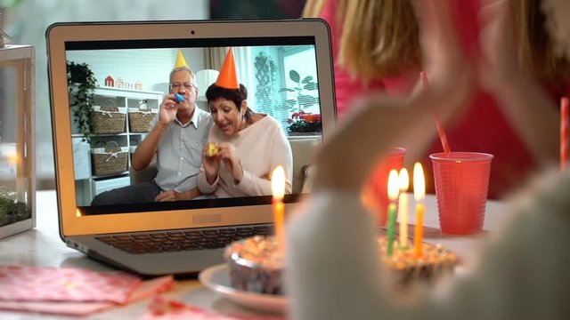 Happy Grandpa and Grandma Congratulate their Grandchildren Happy Birthday Using Laptop Video Call. Social distancing, self isolation during quarantine