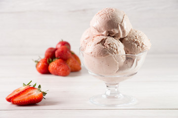 Strawberry ice cream in a flask on a light background