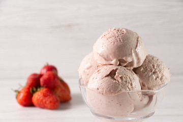 Strawberry ice cream in a flask on a light background