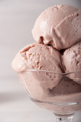 Strawberry ice cream in a flask on a light background
