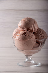 Strawberry ice cream in a flask on a light background
