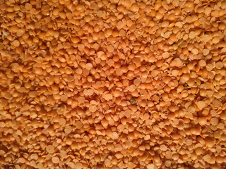 Red raw organic lentils texture. Food ingredient background. Natural