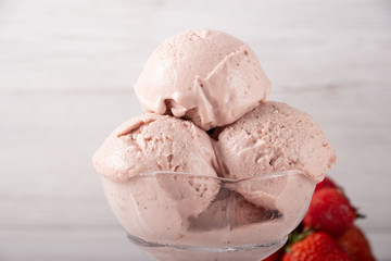 Strawberry ice cream in a flask on a light background