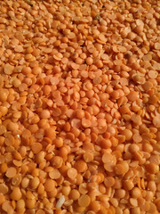 Red raw organic lentils texture. Food ingredient background. Natural
