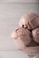 Strawberry ice cream in a flask on a light background