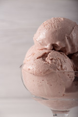 Strawberry ice cream in a flask on a light background