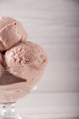 Strawberry ice cream in a flask on a light background