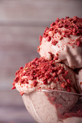 Strawberry ice cream in a flask on a light background