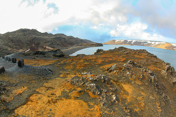 A beautiful calm lake and the volcanic soil in Iceland