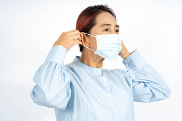 An Asian adult put on medical face mask. Woman Wearing Protective Mask preventing infection of  Corona virus or pm2.5 dust environment, on white background