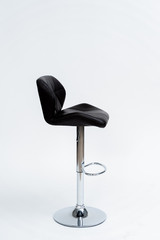 chrome-plated bar stool with black padded seat